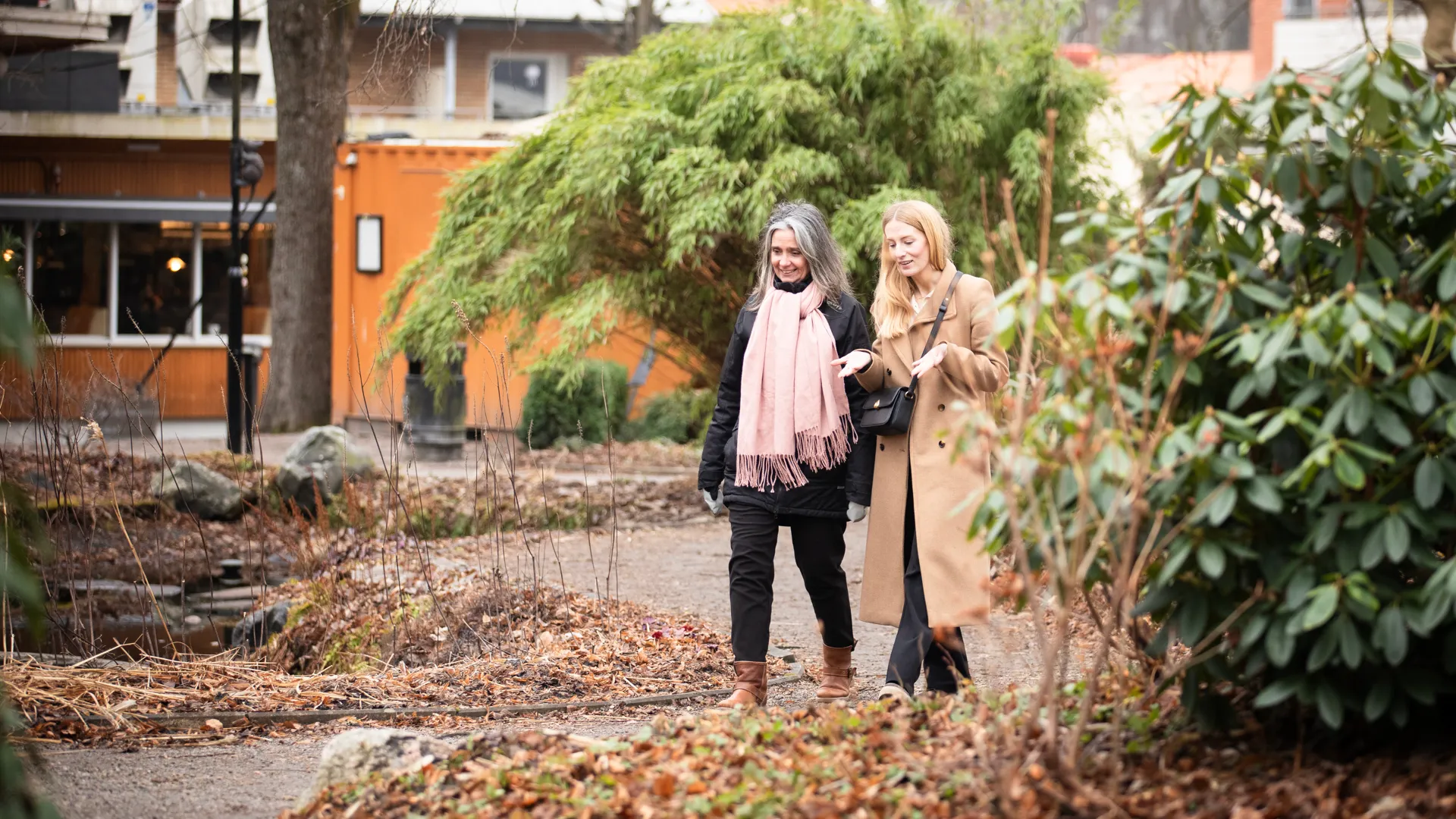 Två personer som pratar med varandra i en park.